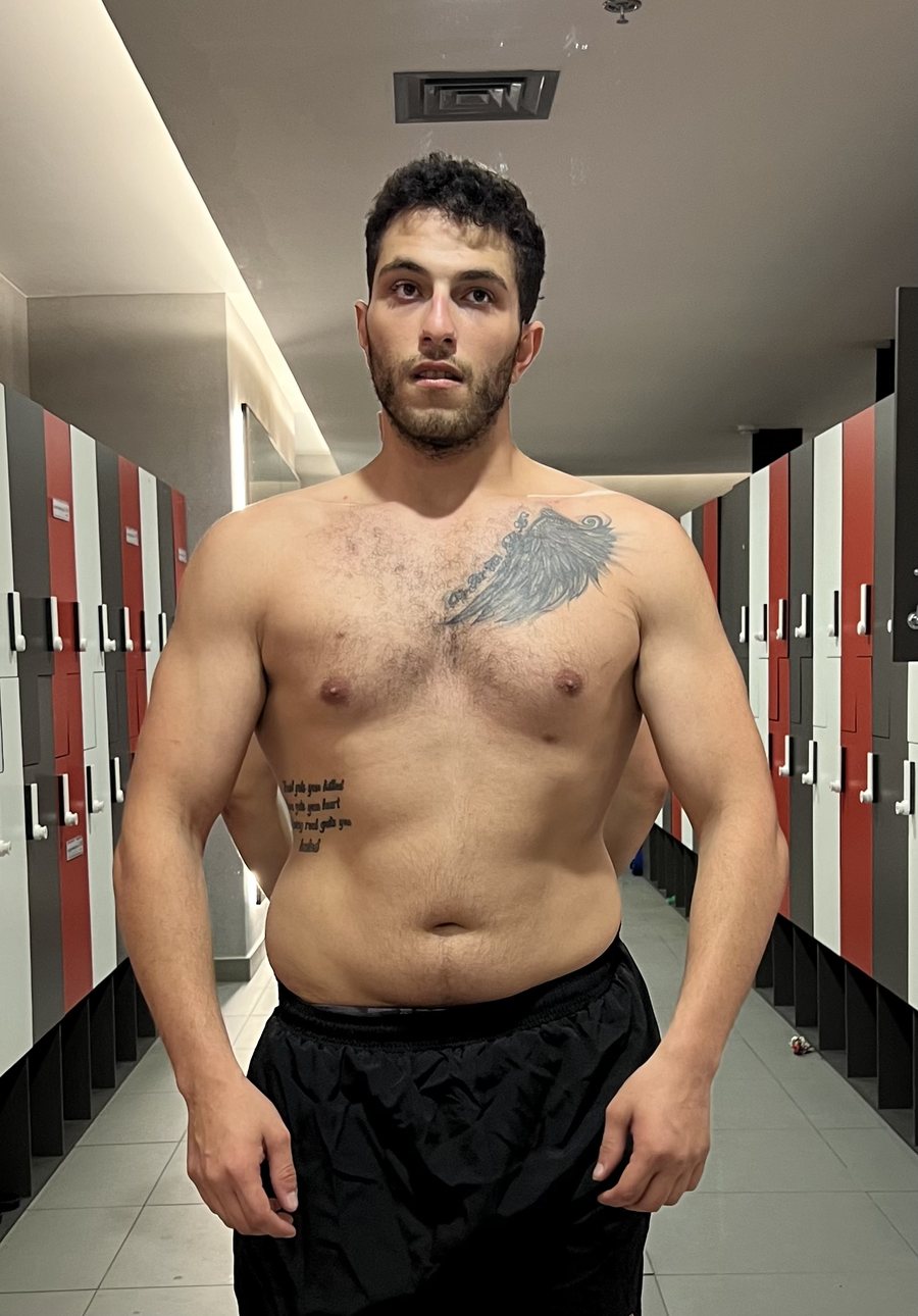 John before starting personal training, standing front-on in the Nogs Gym changing room